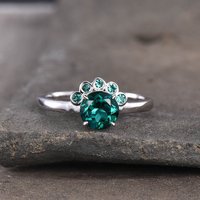 Bague de fiançailles en émeraude et diamants avec cinq pierres