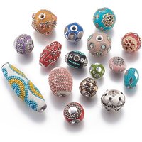 Perles artisanales d'Indonésie avec éléments en métal, formes et couleurs variées