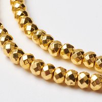Fil de perles en hématite synthétique, facettées, dorées